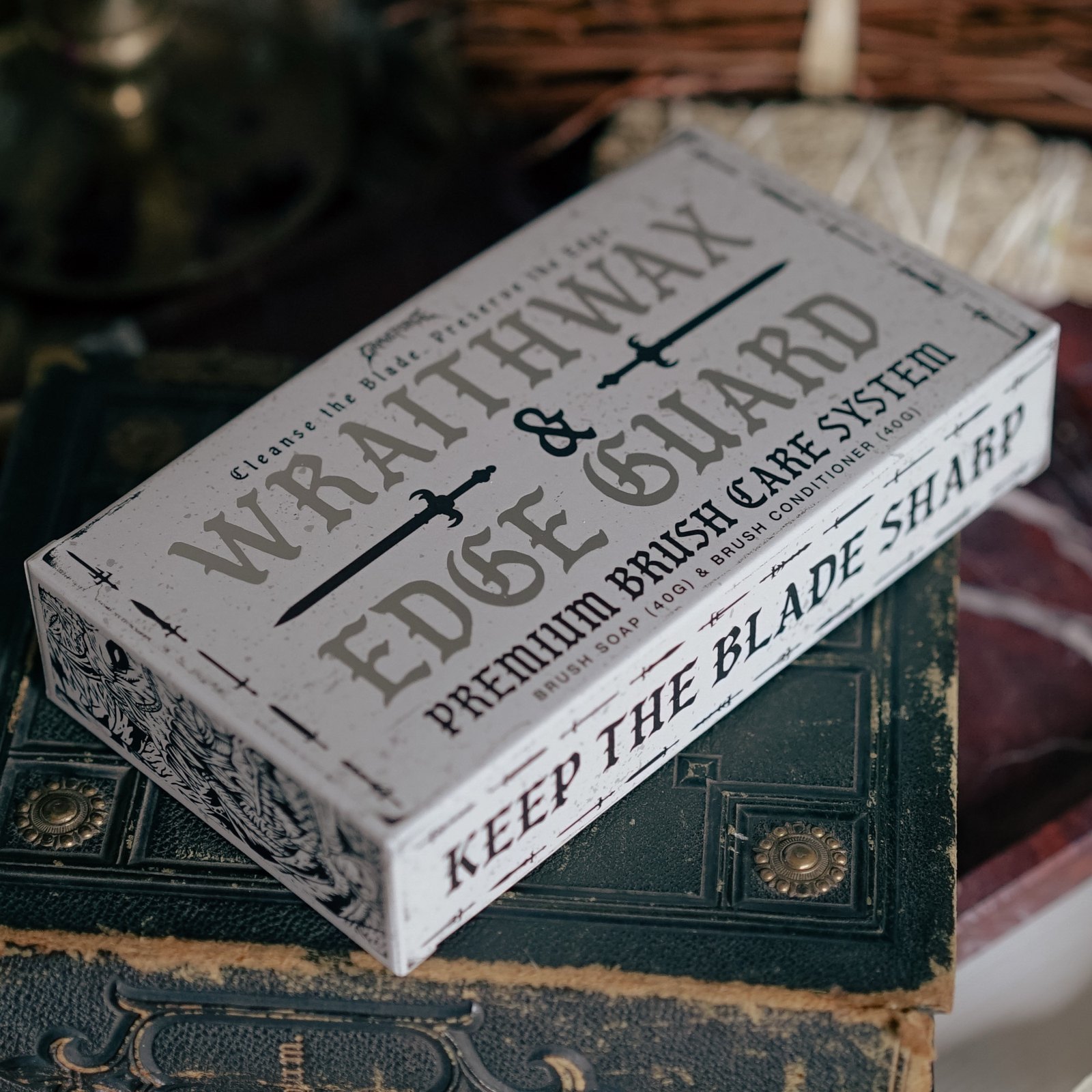 Wraithwax & Edge Guard brush care box on a leather-bound book